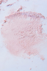 Cosmetic powder, swatch on paper, abstract background