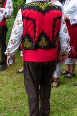 People in traditional costumes dance bulgarian