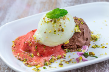 Variety of ice cream in bowls. Fresh, ice creams and sorbet.Variety with mint and pistachio