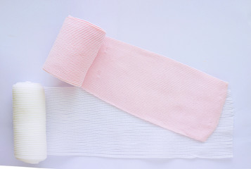 Roll elastic bandage and gauze on white background