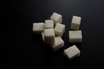 sugar cubes on black background
