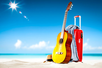 Summer suitcase on beach and travel time. Free space for your decoration and sunny day. 