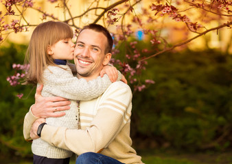Fototapeta premium Close up portrait pretty daughter embracing Caucasian father. Family enjoy spend time together. Happy diverse family