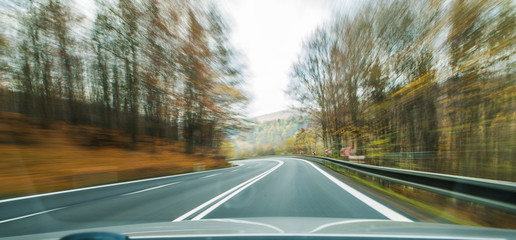 Front view of the highway road passing the country side inside the fast car long exposure shoot