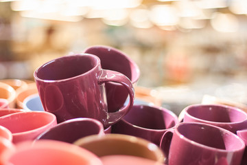 Many colorful empty ceramic cups in store, Mugs background