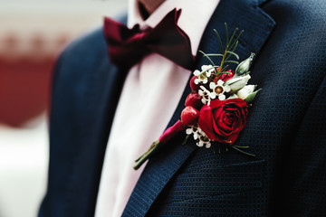 Groom's boutonniere on the jacket red red rose - obrazy, fototapety, plakaty