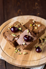 Tasty Homemade Dessert Chocolate Brownie Decorated with Berry and Nuts on Wooden Tray Homemade Dessert Vertical Above