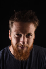 portrait of a man close up looking at camera on black background