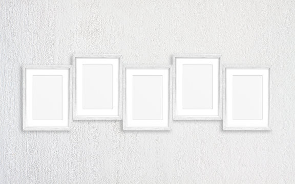 Photo frames collage, five white realistic frameworks mock up isolated on white plastered wall, interior decor elements