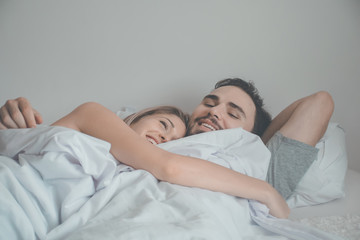 loving couple sleeping in bed.happy couple lying together in bed.women with husband sleeping in bedroom