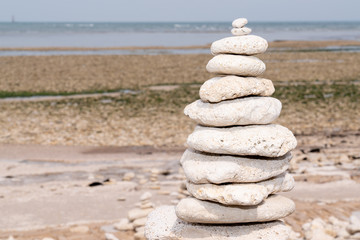 Fototapeta na wymiar made of stone tower on the beach in zen pyramid