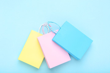 Small paper shopping bags on blue background