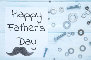 Text Happy Fathers Day with tools on wooden table