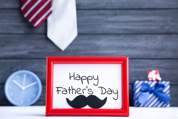 Fototapeta na wymiar Text Happy Fathers Day in frame with black mustache and neckties on black background