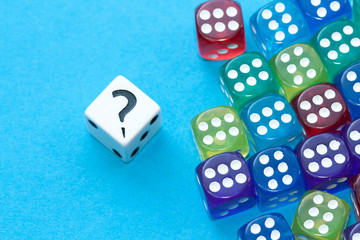 Gaming dices and question mark on blue background.