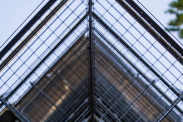 Obraz premium Background or texture in the blue sky of a crossbeam from building lattices. View of balconies from below. Cage, grid, wire.