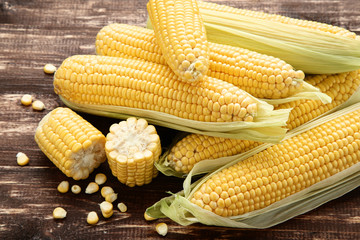 Ripe corn on brown wooden table