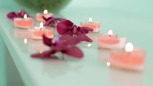 Beautiful spa composition with orchid flowers on table slow motion
