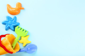 Plastic beach toys on blue background