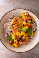 Grilled chicken with mango avocado salsa and rice, top view
