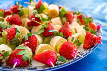 strawberries and other exotic fruits pinned with sticks
