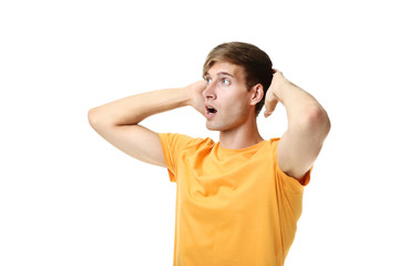 Emotional young man in yellow t-shirt isolated on white background