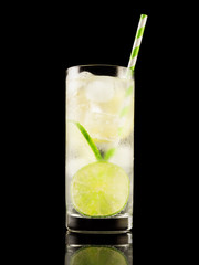 Citrus summer cold coctail or lemonad with ice on black background. Studio shot. Alcohol tasty drink.