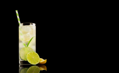 Citrus summer cold coctail or lemonad with ice on black background. Studio shot. Alcohol tasty drink.