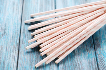 Paper straws on blue wooden table