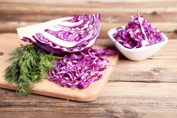 Red cabbage with green dill on brown wooden table