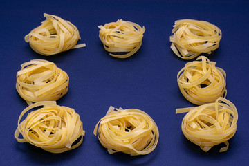 Dry pasta yellow on a dark background. Italian food
