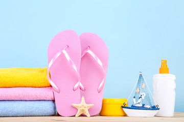 Fashion clothing with sunscreen and starfish on blue background