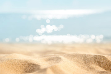 Fototapeta na wymiar Summer tropical sand beach and bokeh sun light on sea background, copy space.