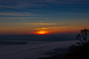 Fototapeta na wymiar Sunrise and mountain mist at doi samer dao Sri Nan National Park thailand