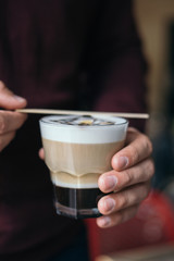 Man holding coffee in hand lifestyle instagram shoot