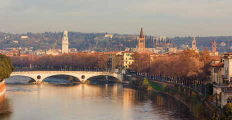 Fototapeta premium Winter view of Verona historic city center with ancient towers and River Adige