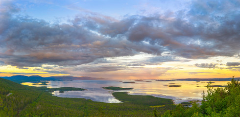 Fototapeta na wymiar Aerial view of Colorful sunset landscape on the coast of the North Sea. Karelian pine on the rocks on the shore of the White Sea. Coast Murmansk region, Kandalaksha Nature Reserve.