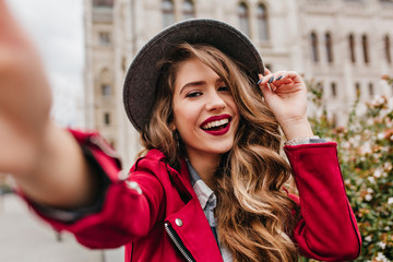 Portrait of wonderful white female model with bright makeup expressing energy in good day in...