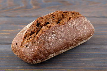Black bread on a wooden table