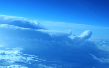 aerial view from plane, blue sky with clouds and sun