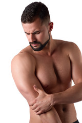 Naklejka premium Muscular strong man with shoulder pain, isolated on white background. Sportsman holds his sore shoulder
