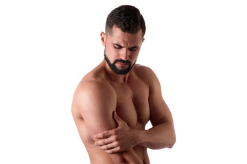 Fototapeta premium Muscular strong man with shoulder pain, isolated on white background. Sportsman holds his sore shoulder