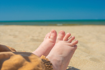 bare children's feet on the beach. close-up