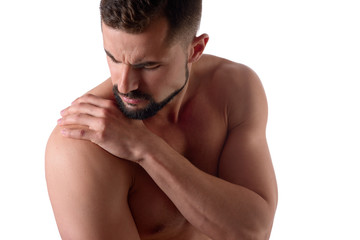Muscular strong man with shoulder pain, isolated on white background. Sportsman holds his sore...