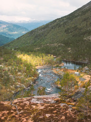 Nature Landscape of Norway, view from the high stone plateau on the mountains, forest, river and fjord in the National Park the valley of waterfall the Husedalen 