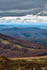 A beautiful panoramic mysterious view of the forest in the Bieszczady mountains (Poland) on a misty rainy spring May day, nature is lonely - without people