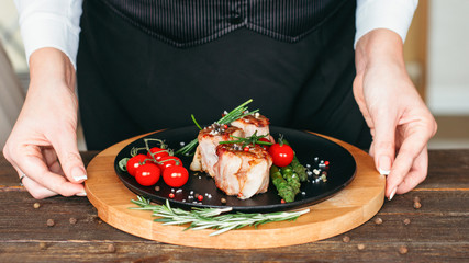 Food styling and restaurant meal serving. Grilled tenderloin medallions with vegetables