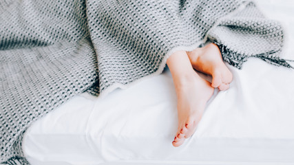 Foot care concept. Treatment and wellness. Beauty and relaxation. Female legs peeking out from...