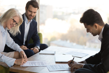 Happy business partners sign contract at briefing