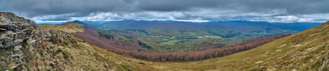 Obraz premium A beautiful panoramic mysterious view of the forest in the Bieszczady mountains (Poland) on a misty rainy spring May day, nature is lonely - without people
